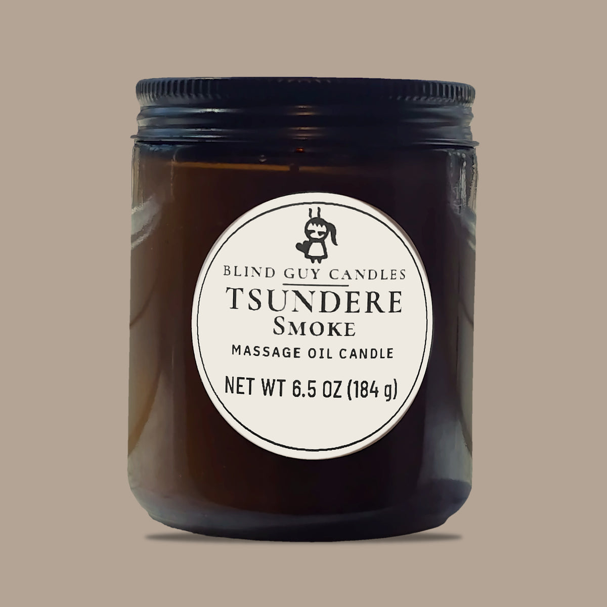 Tsundere Smoke massage oil candle, amber glass jar with black lid, on a plain light background
